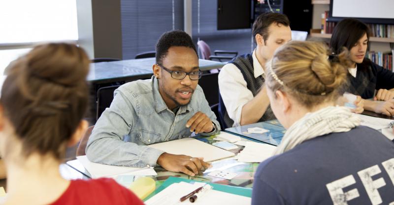 UTEP students gathered around a table engage in a discussion