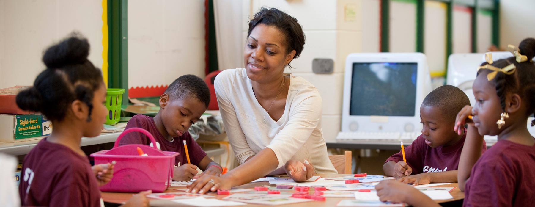 A female teacher in her classroom with students